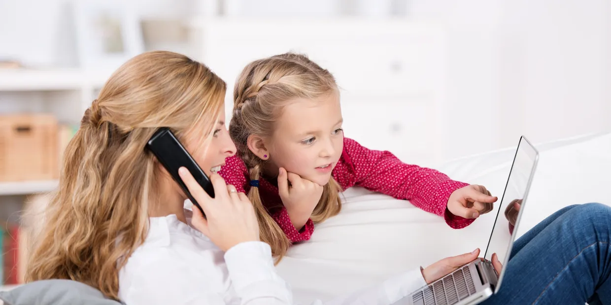 Family using phone and laptop